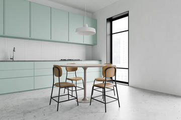 Green kitchen corner with round table