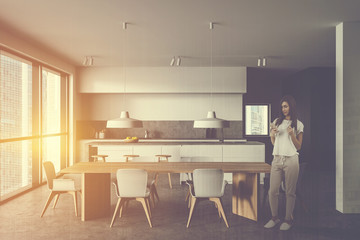 Woman in stylish gray and white kitchen
