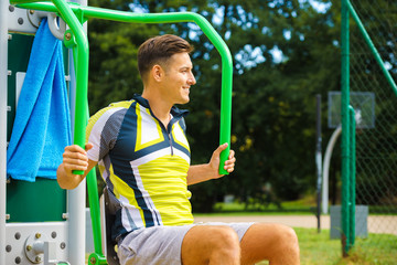 Man flexing arm in outdoor gym