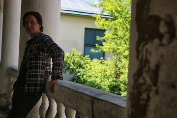 man sit on abandoned stair