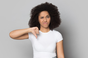 African american frowning female client showing thumbs down gesture.
