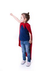 Adorable little girl flying like a superhero in blue t-shirt and red mantle. Super girl. The new generation saves the world. Good triumphs over evil. Funny kid portrait