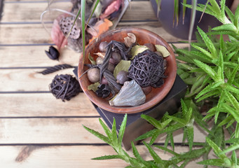 potpourri and succulent plant in pot on a wooden table