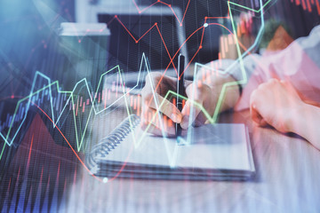 Forex chart displayed on woman's hand taking notes background. Concept of research. Double exposure