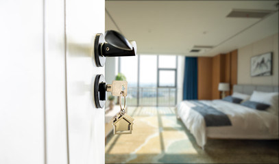 Open door with keys, key in keyhole