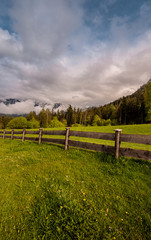 Fototapeta premium mountain landscape with green field and blue sky