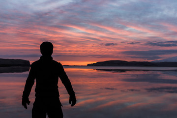 Sunset over a lake in Scandinavia with figure in foreground