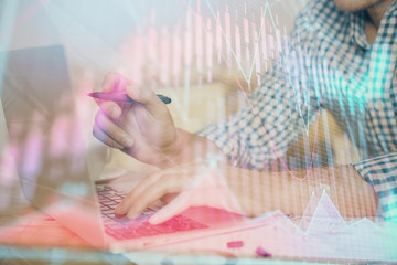 Multi exposure of forex graph with man working on computer on background. Concept of market analysis.