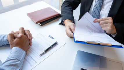 Interview the job and hiring, men candidate at job interview explaining about his profile to business manager in modern office space. Business consulting or employment concept.