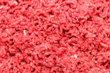 Minced meat.  Chopped meat through manual meat grinder close-up. Copy space on the background of...