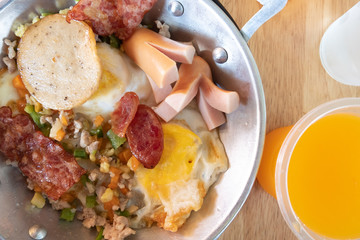 Indochina Pan-Fried Egg with Toppings (pork, sausage, Vietnamese sausage, Chinese sausage, carrot, fried egg). Easy Breakfast food Thai Style in Morning.