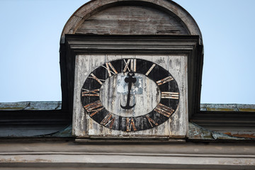 Old white church tower close-up detail shot with ancient wood watch.