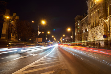 Fototapeta na wymiar Street and car traffic during the night in Poznan..