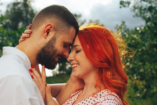 happy, couple in love cuddling, Redhead girl. minute to kiss. date
