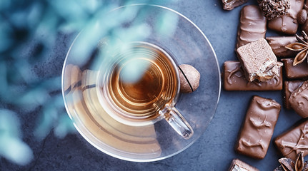 Chocolate bars on a black background in backlight. Chocolate with filling. Sweet sweets for snack and tea.