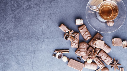 Chocolate bars on a black background in backlight. Chocolate with filling. Sweet sweets for snack and tea.