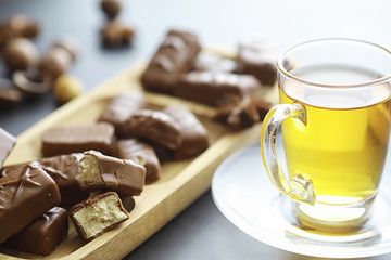Chocolate bars on a black background in backlight. Chocolate with filling. Sweet sweets for snack and tea.