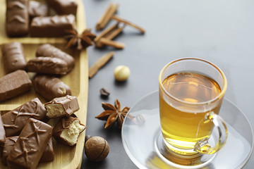 Chocolate bars on a black background in backlight. Chocolate with filling. Sweet sweets for snack and tea.