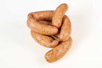 Tasty meat sausages over white background