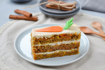Carrot cake for mother's Day.  Layer cake with grated carrots, walnuts and dried apricots, topped with cream cheese and frosting. A delightful pleasure to relax.National holiday.  Close-up, top view.