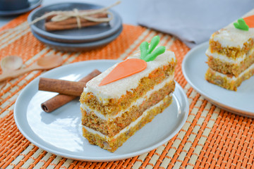 Carrot cake for mother's Day.  Layer cake with grated carrots, walnuts and dried apricots, topped with cream cheese and frosting. A delightful pleasure to relax.National holiday.  Close-up, top view.