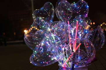 Heart shaped balloons and neon swords in the dark