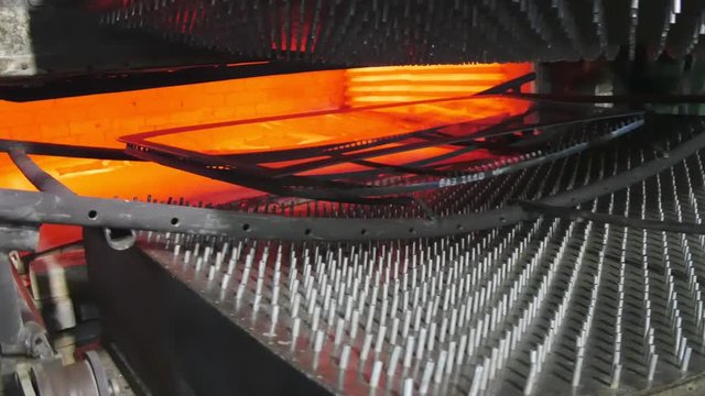 Annealed glass in a furnace.A glass factory.Cart with glass goes into the oven.