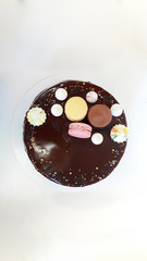 Cake with macarons, marshmallows and candy