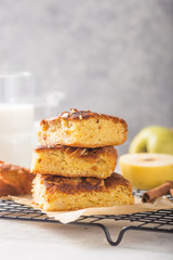 Homemade blondie (blonde) brownies apple cake square slices with glass of milk