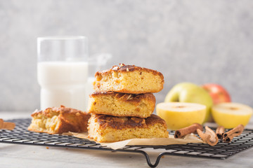 Homemade blondie (blonde) brownies apple cake square slices with glass of milk