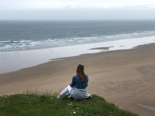 woman standing with her back looking at the sea, beautiful nature,