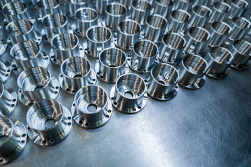 Shiny metal aerospace parts after cnc machining on steel surface with selective focus, industrial...