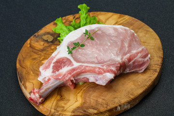 Raw pork bone steak over wooden