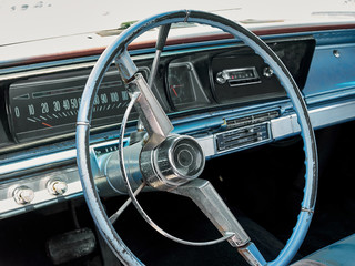 Steering wheel and panel with dashboard in interior of old retro american car