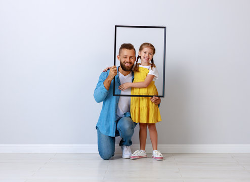 concept of the family. father and child to daughter near empty wall