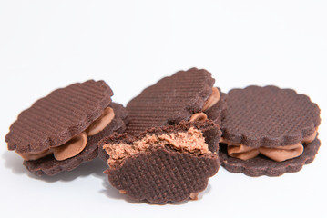 sandwich brown biscuits with brown cream on white background
