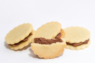 Fototapeta na wymiar sandwich white biscuits with brown cream on white background