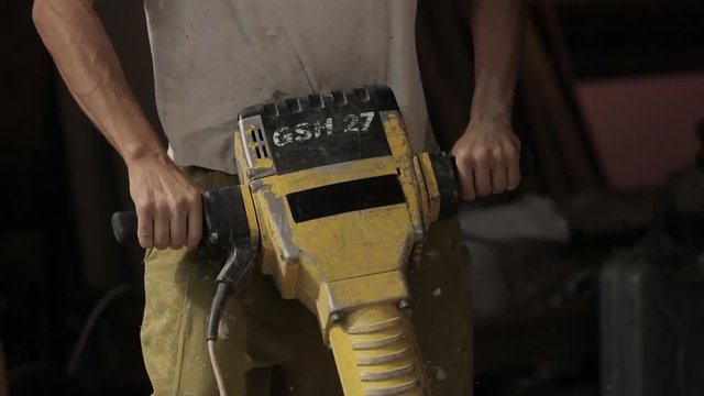 Professional electric tools. Work of a jackhammer. Close Up