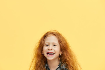 Positive vibrations, happy childhood, joy and serenity concept. Beautiful cheerful red haired...