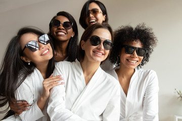 Happy diverse girls in sunglasses have fun at party