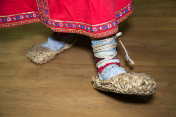 Village bast shoes made of bast worn on woolen socks women, part of the beautiful national pattern...