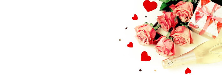 Valentine's day background banner. Bouquet of pink roses flowers, gift box and champagne bottle isolated on white background with copy space toned. Top view flat lay