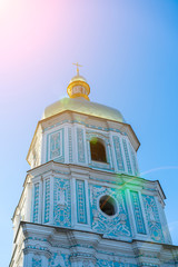 Orthodox bell tower against the blue sky in the sun. The concept of the Orthodox faith. Vertical photo