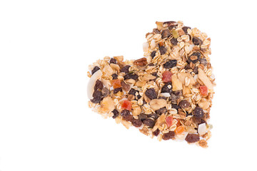 Muesli with nuts and dried fruits isolated on a white background, close up