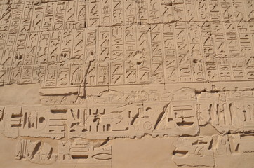 Ancient Egyptian murals and writings on the stone walls of the Karnak Temple in Luxor