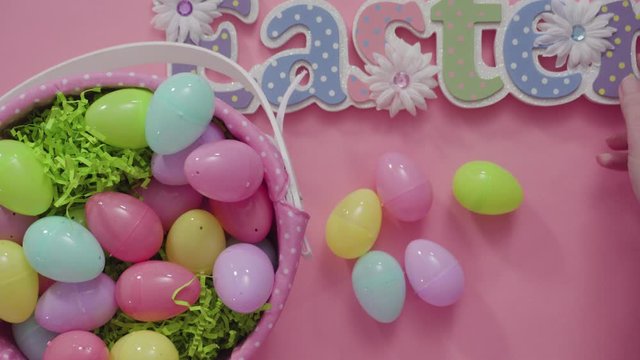 Flat lay. Easter basket with easter eggs on a pink background.