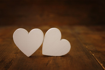 Valentines day concept. white hearts over wooden background. Flat lay composition