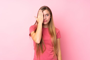 Obraz na płótnie Canvas Teenager blonde girl over isolated pink background covering a eye by hand