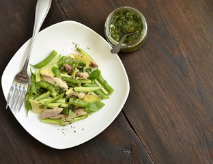 Chicken salad with zucchini, green beans and basil pesto, top view, copy space