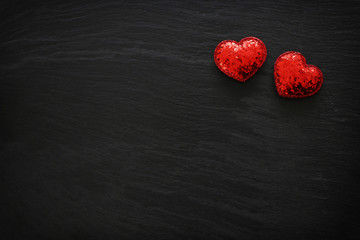 Valentines day concept. red glitter hearts over black background. Flat lay composition